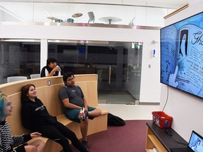 Wallaceburg District High School students Sunny Gamble, Elora Knight-Williams, Jayden Williams and returning Ty Williams watch an episode of Gravity Falls at the school's student center.  Tom Morrison/Postmedia Network