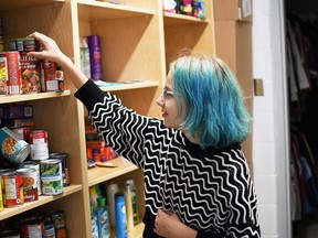 Sunny Gamble, a Grade 8 student at Wallaceburg District Secondary School, takes a look at an item in the free pantry at the school's student hub. Tom Morrison/Postmedia Network