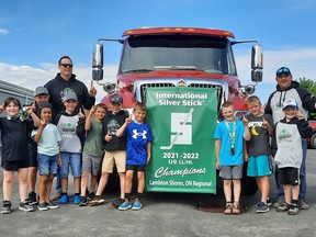 The undefeated Silver Stick Champions gather around their banner attached to the fire engine before the celebratory parade.  Victoria Acres