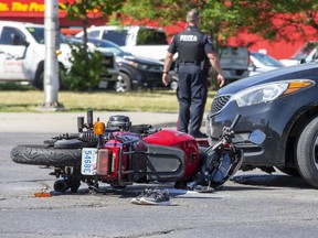 Two people were taken to hospital and the intersection was partially closed after a collision between a car and a motorcycle at Highbury Avenue and Dundas Street in London on June 28. Derek Ruttan/Postmedia