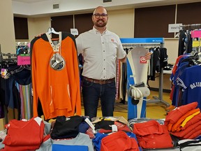 Jory Hewson from The Salvation Army in Owen Sound displays just a few of the items recently donated by Janice and Brian Warrilow who closed their long-running Garb and Gear sporting goods store in the city this spring. The Warrilows donated the remaining inventory to the Salvation Army. Photo supplied
