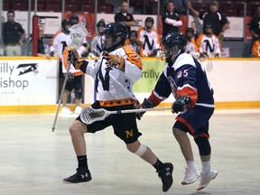 Dustin Lantz runs away from Cam Mancini in the second period as the Owen Sound North Stars host the Oakville Rock in Ontario Series Lacrosse action at the Harry Lumley Bayshore Community Centre on June 4, 2022. Greg Cowan/The Sun Times