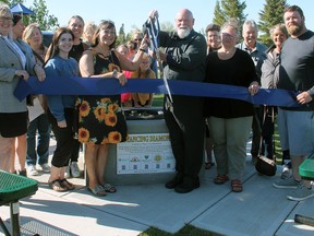 Millet Mayor Doug Peel and SMILES founder Rita-Anne Fuss cut the ribbon to officially hand over the distancing diamonds in Millet to the Town of Millet.
Christina Max