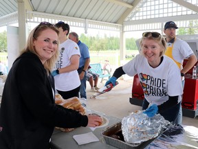 Becky Brown, left, was served a burger by Deb Hurlock, Pembina equity, diversity and inclusion senior specialist.