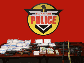 More than ten kilograms of drugs and 18 firearms were seized during multiple searches on Thursday by Six Nations Police, OPP and Brantford Police.