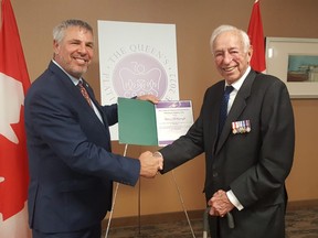 Former MPP Darcy McKeough, right, accepts his Platinum Jubilee pin from Chatham-Kent-Leamington MP Dave Epp at the John D. Bradley Convention Centre in Chatham on Thursday. More than 30 people were on hand to receive their pin, with other nominees slated to accept them at a later date. (Trevor Terfloth/The Daily News)