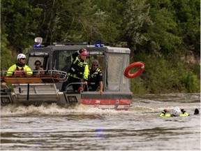 Edmonton Fire Rescue Service firefighters demonstrate a river rescue on the North Saskatchewan River near Wilfred Laurier Park boat launch. IAN KUCERAK/Postmedia File