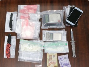 Police seized illegal drugs, weapons and money from a Port Dover property on Thursday. Two people are facing charges.