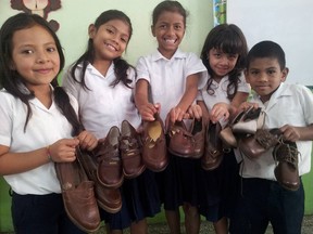 Students from Sarchi North Elementary School show off shoes that were given to them by North Bay and Area students enrolled in the Duke of Edinburgh program. The program, which is organized by Nipissing Parry Sound Catholic District School Board educational assistant Andy Hazlewood, has raised more than $340,000 to help students and their families in Costa Rica. This will be the final year of the program.