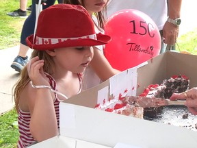 Ellie and Scarlett Thornton watch as their Canada Day / Tillsonburg 150th birthday cake is cut Friday at Annandale National Historic Site. CHRIS ABBOTT