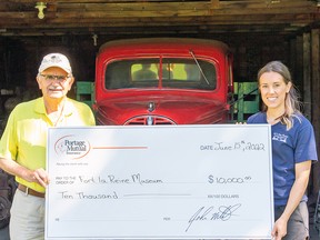 Tom McCartney, past president of Portage Mutual (left) with Emma Ens-MacIver of the Fort la Reine Museum(right). (supplied photo)