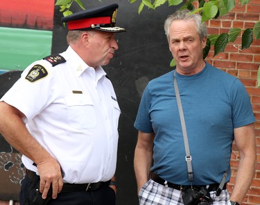 Hugh Stevenson, chief of Sault Ste. Marie Police Service, speaks with former chief Bob Davies at a barbecue at Albert and Gore streets near the former Neighbourhood Resource Centre on Thursday, July 7, 2022 in Sault Ste. Marie, Ont. (BRIAN KELLY/THE SAULT STAR/POSTMEDIA NETWORK)