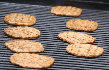 Hamburgers on barbecue at Albert and Gore streets near the former Neighbourhood Resource Centre on Thursday, July 7, 2022 in Sault Ste. Marie, Ont. (BRIAN KELLY/THE SAULT STAR/POSTMEDIA NETWORK)