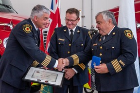 Perth East-West Perth fire Chief Bill Hunter (left) and West Perth deputy station Chief Ken Monden present West Perth station Chief Jim Tubb with a certificate recognizing his 40 years of service as a firefighter.  Chris Montanini/Stratford Beacon Herald