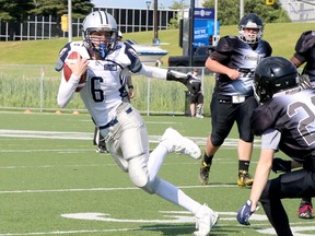 Sudbury Junior Spartans quarterback Riley Worton (6) tries to avoid tacklers from the Clarington Knights during Ontario Summer Football League U16 action at James Jerome Sports Complex in Sudbury, Ontario on Saturday, July 9, 2022.