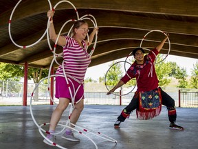Jay-me White participates in a hoop dancing lesson as she embodies the form of a bear while she dances alongside Nimkii Osawamick, an Indigenous hoop dancer and singer, during Belleville's Waterfront and Multicultural Festival on Saturday. ALEX FILIPE