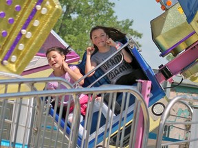 A couple of fair-goers having a blast on one of the rides at the Portage Ex this year. The weekend played out perfectly for people to enjoy the rides, games and food on the Island. (Aaron Wilgosh/Postmedia)