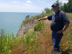 Jim Shanks, a lifelong Talbot Trail resident in Chatham-Kent, shows the erosion that has occurred on his property, located on the shores of Lake Erie.  He lives on a stretch of road that's currently closed off to non-local traffic.  (Trevor Terfloth/The Daily News)
