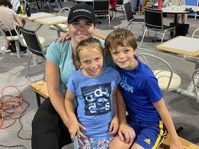 Gen Kmith poses with her children Jillian and Fred. Jillian was diagnosed with Stage Three abdominal cancer three years ago. The eight-year-old underwent surgery to remove the tumor and now enjoys playing sports like badminton.