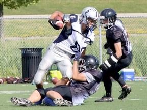 Sudbury Junior Spartans receiver Cody Osawamick (82) is hauled down after catching a pass during Ontario Summer Football League action at James Jerome Sports Complex in Sudbury, Ontario on Saturday, July 9, 2022.