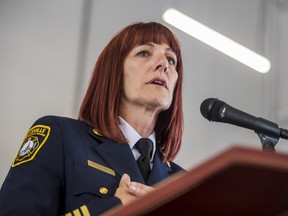 Belleville Fire Chief Monique Belair holds her hands to her chest as she thanks the volunteers, sponsors and the Camp Molly graduates during the camp's graduation ceremony on Sunday inside the Belleville Fire Headquarters. ALEX FILIPE