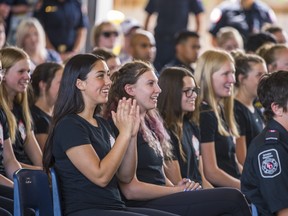 Aaliyah Valentiate applauds as she and her fellow Camp Molly attendees smile while participating in the camp's graduation ceremony on Sunday inside the Belleville Fire Headquarters. ALEX FILIPE
