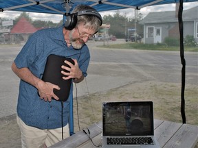 Darren Copeland is able to hear and feel the sticks being dragged across the steel drum in the video displayed on the laptop. The bodily listening display is one of several outdoor exhibits this summer at New Adventures in Sound Art in South River.