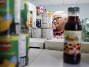 Ruth McCrory, the vice-chair and treasurer of Stirling and Area Christian Community Care Inc., stands between shelves at the facility Tuesday morning. Chairperson Heather Bailey is warning farmers not to comply with an e-mailed request from someone claiming to solicit produce donations on the food bank's behalf.