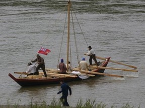 IMG_1940 – York boat Captain Teresa Griffith manoeuvres boat to shore at Peace River’s Riverfront Park, June 4, 2011. At that time, it was about 80 years since the last York boat was known to ply the Peace River. One of the crew (not seen) is on shore to catch the mooring line thrown by a crew member. Note the 40 lb. oars. Also, crew, including Captain Griffith, appear bulky – unlike York boatmen of yore, these wear personal floatation devices (PFD) or lifejackets. As per Transport Canada – required by law “to have a lifejacket, or PFD on board for each person on a watercraft”.