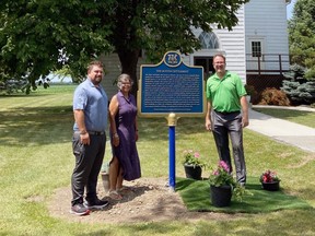 Chatham-Kent Coun. Anthony Ceccacci, Buxton Museum curator Shannon Prince and Mayor Darrin Canniff are shown with updated historic plaque about the Buxton Settlement. (Handout/Postmedia Network)