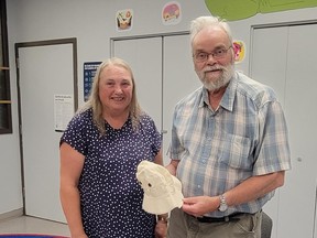 Don Hayward, author, with area resident, Suzanne Mooney who found a hat belonging to Hayward’s mother, Betty Prentice-Hayward, while she was working in the old Temperance Valley schoolhouse. Mooney discovered it on the same day as Hayward was scheduled to give his talk and presented it to the author at the conclusion. Don was quite touched by the gift.