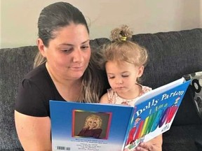 Tammy Ward's daughter Jenna Ferguson of Brantford  reads to her daughter Isla from one of the books selected under the Dolly Parton Imagination Library.