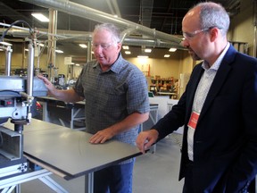 Snapcab founder and CEO Glenn Bostock, on left, tours his facility alongside Mayor Bryan Paterson at the Snapcab manufacturing facilities at 70 Railway St., in Kingston, Ont., on Thursday, July 21, 2022. The company will be building a 18,000 square foot expansion to its existing facility and hopes to double their employees. (Steph Crosier/The Whig-Standard/Postmedia Network)