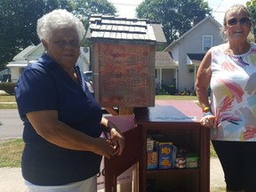 Dorothy Wright-Wallace, president of the Chatham-Kent Black Historical Society, left, and Geri Hughson, founder of FreeHelpCK, are shown beside the new food pantry at BME Freedom Park in Chatham. (Trevor Terfloth/The Daily News)