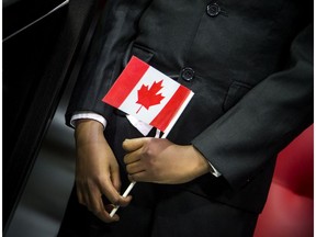 A young man participates in a citizenship ceremony in Ottawa. Immigrants make Canada stronger.