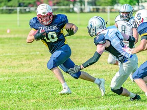 Brock Hoover of the Sault Steelers evades a swarm of Sudbury Spartans during Northern Football Conference action at Rocky DiPietro Field. The Steelers scored a dramatic come from behind victory over the Spartans on Saturday. BOB DAVIES