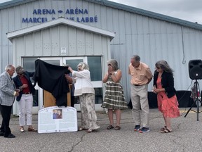 Jane Labbe helps uncover a dedication plaque Saturday that will hang in the Marcel and Jane Labbe Arena, formerly known as the Sturgeon Falls Arena. The arena was renamed to honour the couple who had the vision of building recreational facilities in Sturgeon Falls.