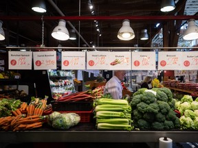 People shop for produce at the Granville Island Market in Vancouver, on Wednesday, July 20, 2022. As the cost of living rises at the fastest pace in decades, Canadians struggling to put food on the table are turning to community organizations for help. THE CANADIAN PRESS/Darryl Dyck