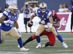 Winnipeg Blue Bombers quarterback Zach Collaros gets sacked by Calgary Stampeders' Mike Rose in Winnipeg, Friday. John Woods/THE CANADIAN PRESS