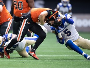 B.C. Lions quarterback Nathan Rourke (12) is sacked by Winnipeg Blue Bombers' Willie Jefferson (5) during the first half on Saturday night.