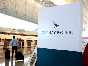 A passenger walks to the First Class counter of Cathay Pacific Airways at Hong Kong Airport in Hong Kong, China April 4, 2018.