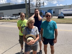 Neighbours Tom Sumner, Joanne Boisvert (front), Eric Cowan, and Mike Boisvert have been rattled by the constant noise of two massive generators delivering power to two nearby businesses after their power transformers blew up.