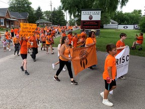 Hundreds marched on Friday wearing orange shirts and shouting 'Every Child Matters'. moving alone Mohawk Street to the Mohawk Institute to honour and remember survivors of the residential school system.