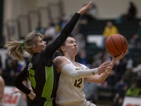 St. Clair’s Jana Kucera drives to the basket while being defended by Algonquin’s Sydney Moore in the OCAA women’s basketball semifinals at the St. Clair College SportsPlex in Windsor, Ont., on Wednesday, March 16, 2022. (DAX MELMER/Windsor Star)