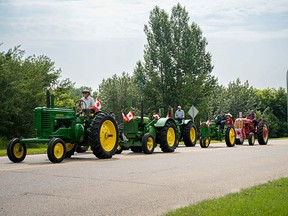 A train of tractors rolls by during the Fort Saskatchewan Canada Day Parade. Photo by the City of Fort Saskatchewan.