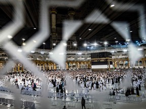 Muslim pilgrims circumbabulate around the Kaaba, Islam's holiest shrine, during the annual Hajj pilgrimage at the Grand Mosque in Saudi Arabia's holy city of Mecca on July 6, 2022. - One million fully vaccinated Muslims, including 850,000 from abroad, are allowed at this year's hajj in the city of Mecca, a big rise after two years of drastically curtailed numbers due to policies to stop the spread of infection. (Photo by Delil SOULEIMAN / AFP)