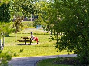 Vicki Wearmouth relaxes in the sunshine at the Nose Creek Regional Park in Airdrie on Friday, July 22, 2022.