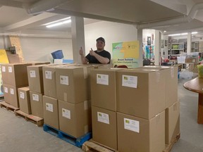 Stephen McPhee stands with some boxed backpacks that are on their way to Montreal to help Ukranian children arriving in Canada, fleeing conflict in their home country. Photo courtesy of Stephen's Backpacks Society