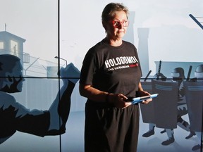 Roma Dzerowicz of the Holodomor National Awareness Tour stands before a video screen aboard the tour's bus Thursday at Glanmore National Historic Site in Belleville. The Holodomor was a 1930s famine in Ukraine sparked by the Union of Soviet Socialist Republics. The tour draws parallels between the factors behind the genocide and issues in modern society.