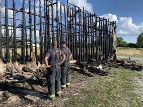 Six Nations District Fire Chief Mark Johnson and Six Nations Fire Chief Ashley Russell-Montour survey the damage following a fire Friday afternoon at the Ogwehoweh Skills and Trades Training Centre Longhouse on Highway 54 near Chiefswood.
